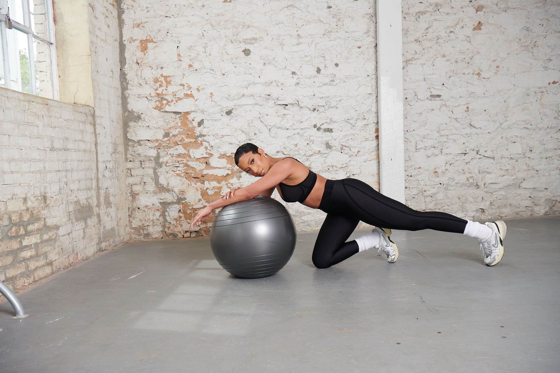 grnd pilates founder, jharde, on a workout ball